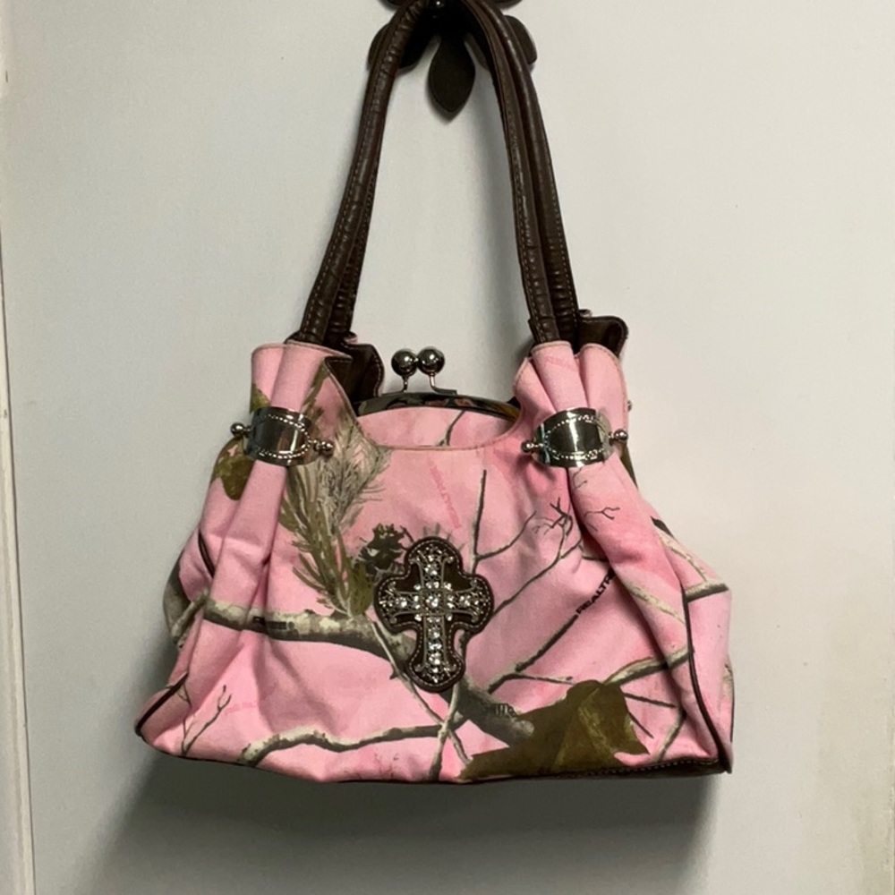 Pink camo material shoulder bag. Large cross on the front